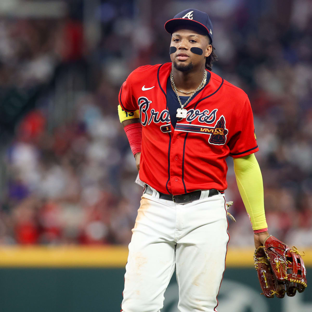 Ronald Acuña Jr. fends off fans on field during Braves-Rockies game