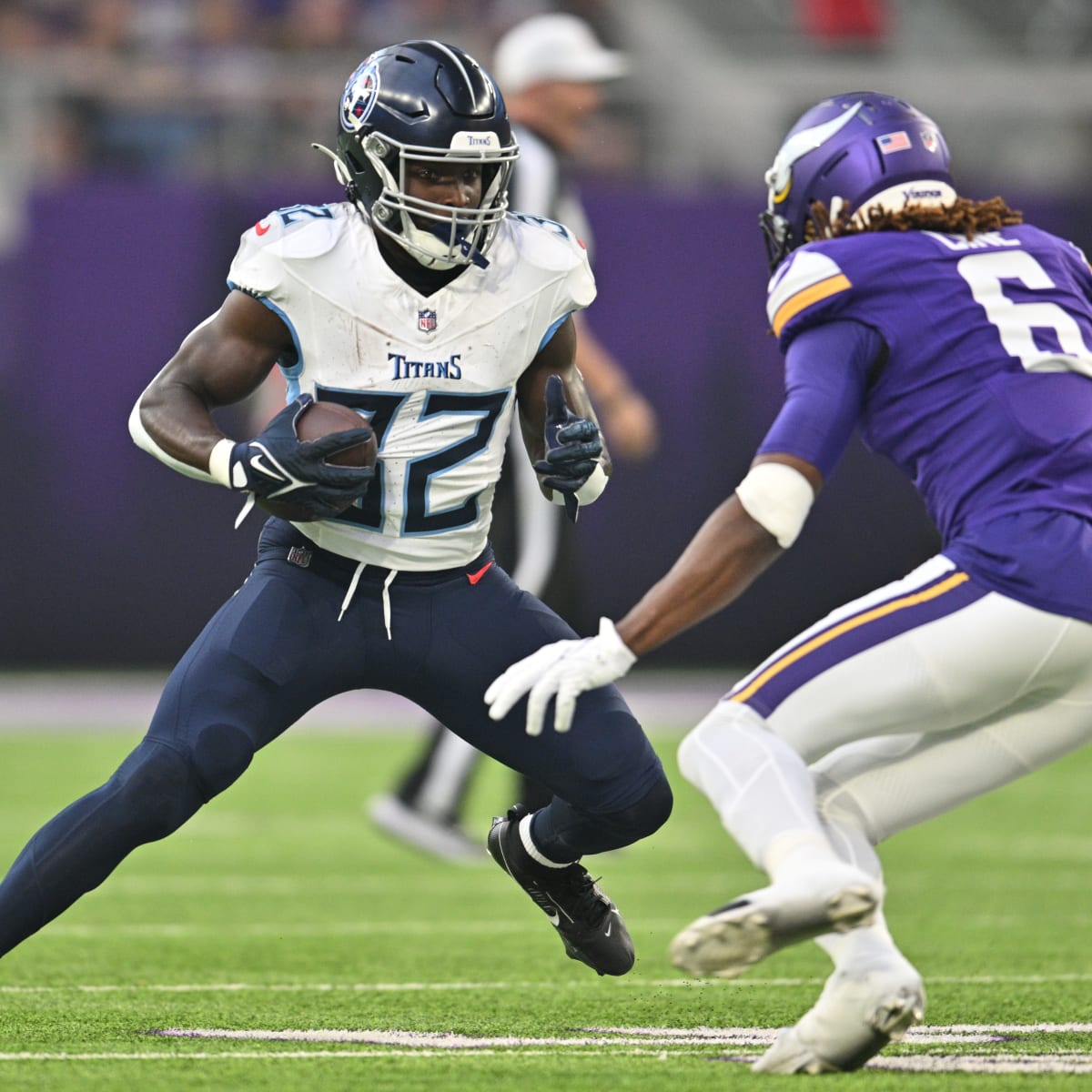 Running back Ty Chandler of the Minnesota Vikings avoids a tackle