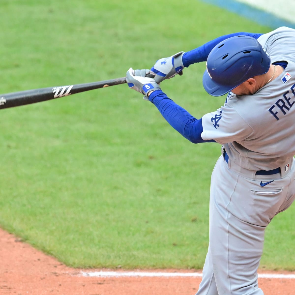 Los Angeles Dodgers' Freddie Freeman holds his batting gloves in his teeth  before the team's baseball game against the New York Mets on Tuesday, Aug.  30, 2022, in New York. (AP Photo/Adam