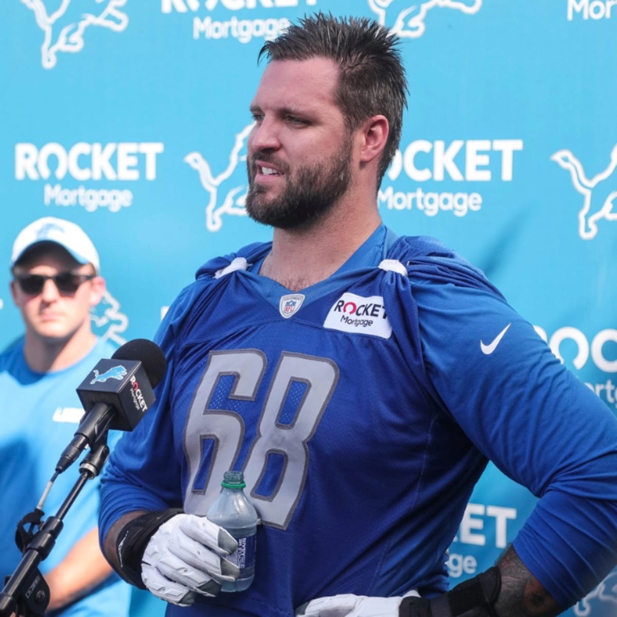 Detroit Lions fans hold up signs for third down against the