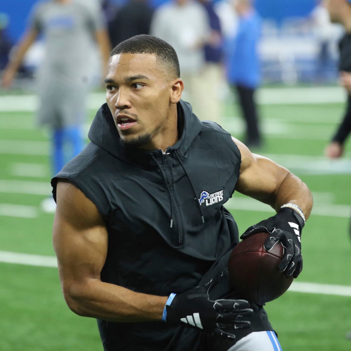 Amon-Ra St. Brown of the Detroit Lions runs with the ball as