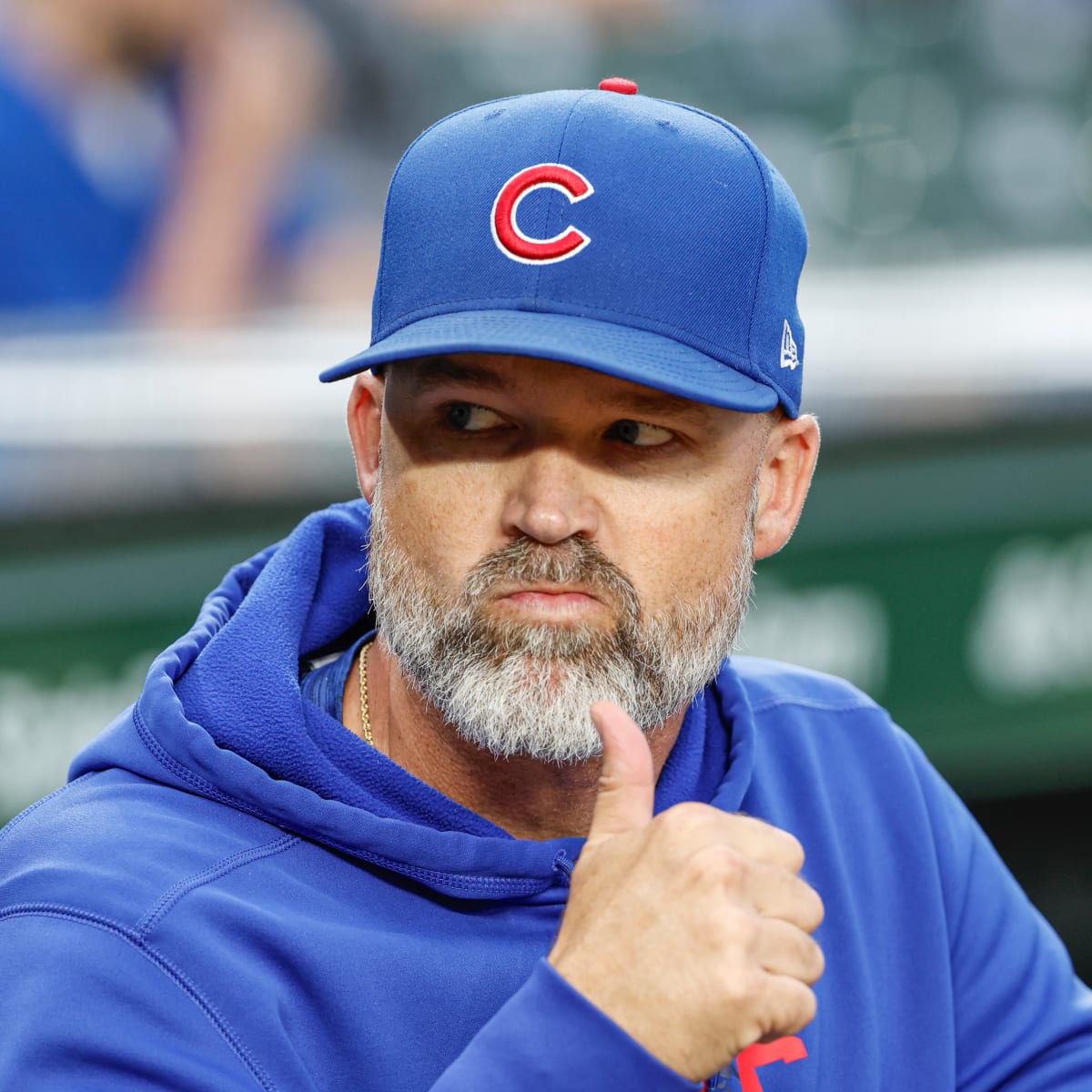 Chicago Cubs manager David Ross stands in the dugout during the