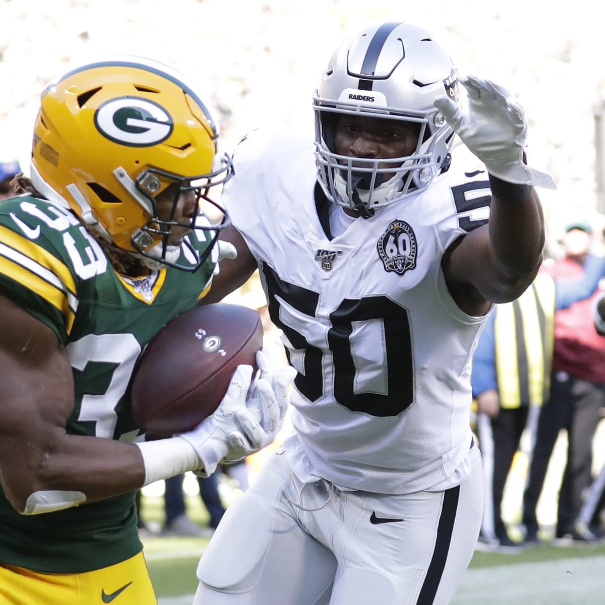 October 2, 2022: Green Bay Packers running back Aaron Jones (33) rushes the  ball during the NFL football game between the New England Patriots and the  Green Bay Packers at Lambeau Field