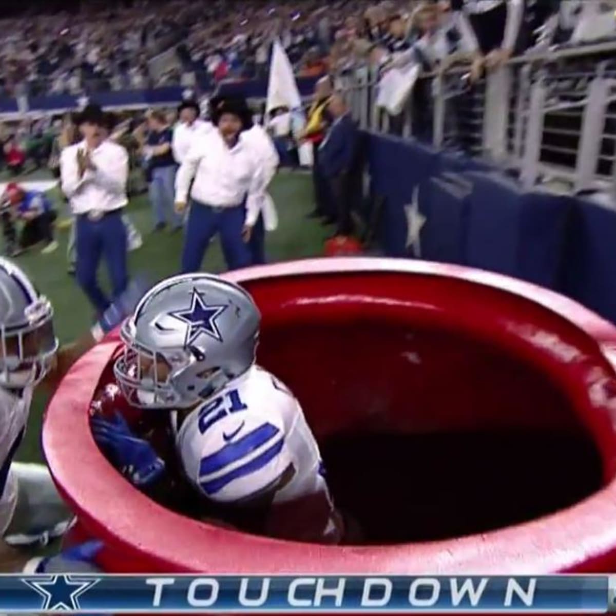 NFL Dallas Cowboys running back Ezekiel Elliott jumps into the Salvation  Army kettle 