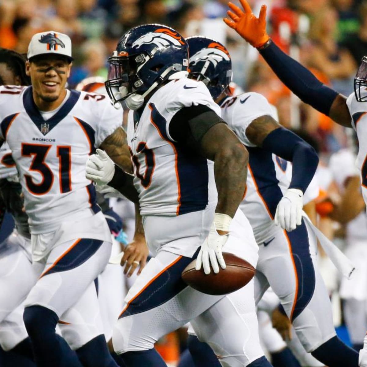 Denver Broncos' Shaun Beyer smiles while on the bench against the Seattle  Seahawks during the second half of an NFL football preseason game,  Saturday, Aug. 21, 2021, in Seattle. The Broncos won