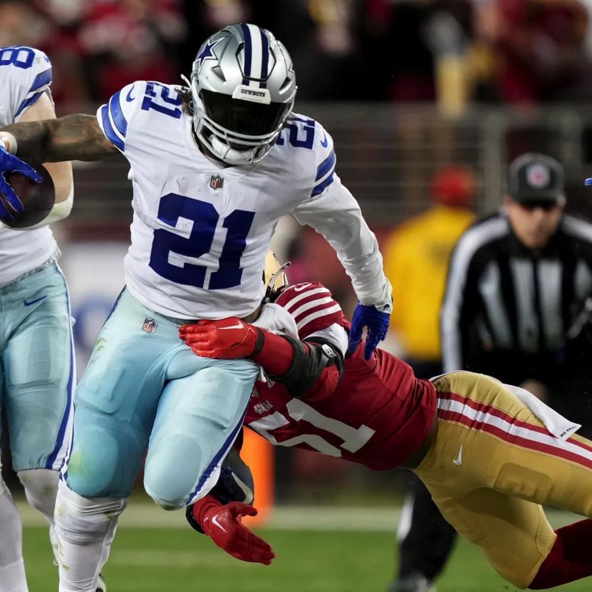 Dallas Cowboys running back Tony Pollard escapes a tackle attempt