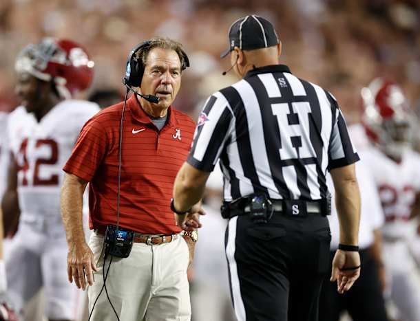 Nick Saban talks to an official