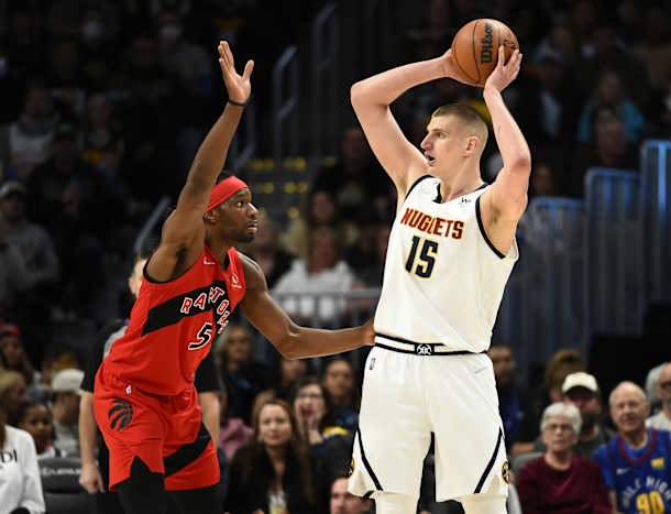 Toronto Raptors forward Precious Achiuwa (5) guards Denver Nuggets center Nikola Jokic (15) during the third quarter at Ball Arena