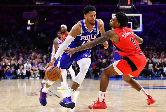 Toronto Raptors guard Armoni Brooks (1) reaches across Philadelphia 76ers forward Tobias Harris (12) in the fourth quarter at Wells Fargo Center.