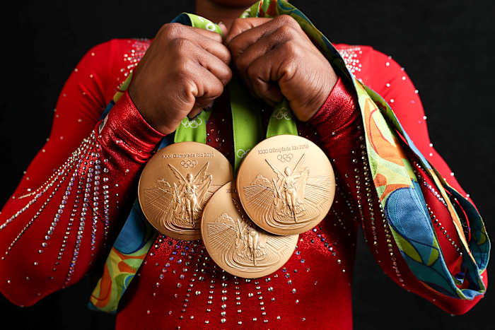 Biles shows off her gold medals from Rio 2016.