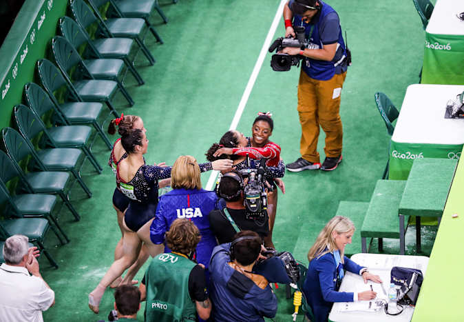 Biles celebrates with teammates at the Rio 2016 Olympics.