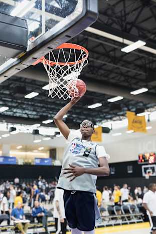 Christian Koloko, the Toronto Raptors' No. 33 pick in the 2022 NBA Draft, dunks a basketball at the 2018 Basketball Without Borders camp in Los Angeles