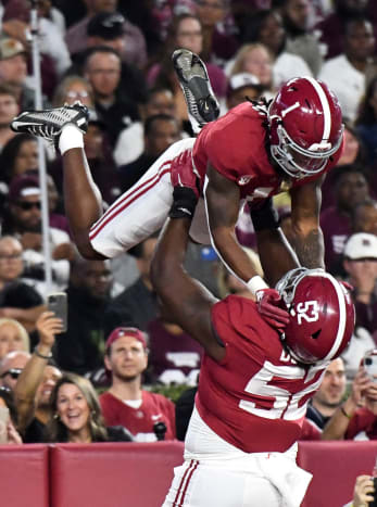 Alabama Crimson Tide running back Jahmyr Gibbs (1) celebrates with offensive lineman Tyler Booker (52) after scoring against the Mississippi State Bulldogs during the first half at Bryant-Denny Stadium.