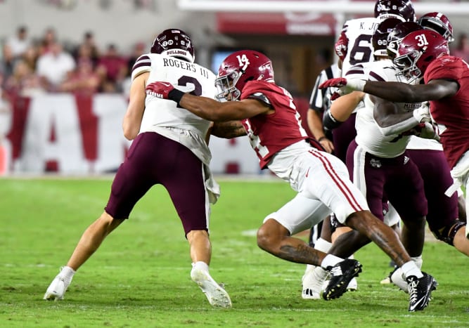 Alabama Crimson Tide defensive back Brian Branch (14) sacks Mississippi State Bulldogs quarterback Will Rogers (2) for a loss during the first half at Bryant-Denny Stadium.