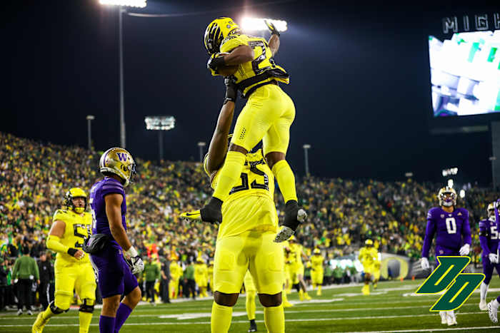 Oregon Ducks running back Noah Whittington celebrates a touchdown with offensive lineman Marcus Harper II.