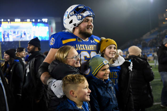 SDSU's offensive lineman Mason McCormick poses with a group after the FCS semifinals against UAlbany on Friday, Dec. 15, 2023 at Dana J. Dykhouse in Brookings.