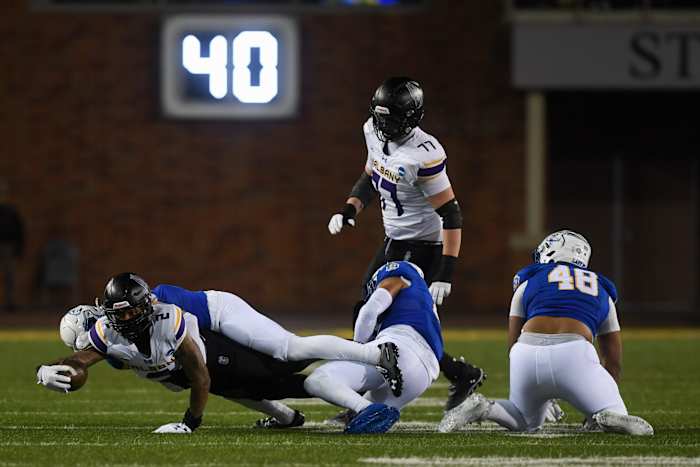 UAlbany wide receiver gets tackled by SDSU player on Friday, Dec. 15, 2023 at Dana J. Dykhouse in Brookings.