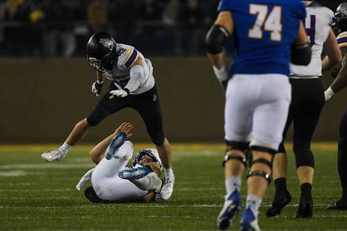 UAlbany's linebacker Dylan Kelly (42) jumps over SDSU player on Friday, Dec. 15, 2023 at Dana J. Dykhouse in Brookings.