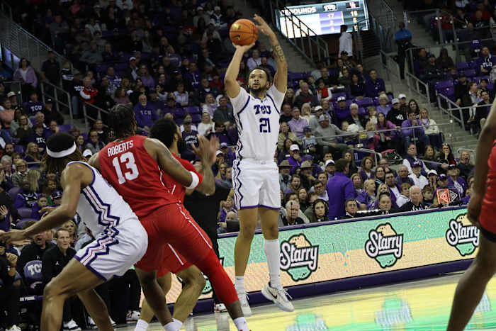 JaKobe Coles (21) tries his luck from beyond the arc.