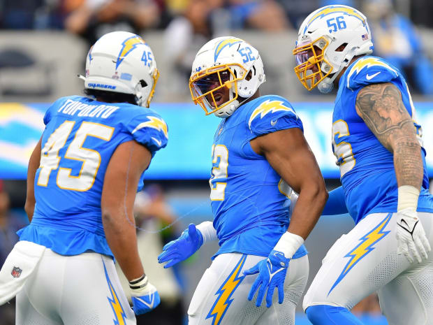 Los Angeles Chargers quarterback Justin Herbert (10) adjusts his helmet as  he warms up before an NFL football game against the Seattle Seahawks  Sunday, Oct. 23, 2022, in Inglewood, Calif. (AP Photo/Marcio