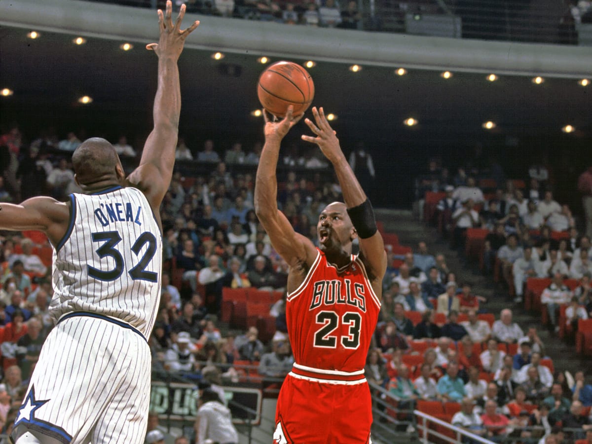 Michael Jordan of the Chicago Bulls shoots against Dennis Johnson