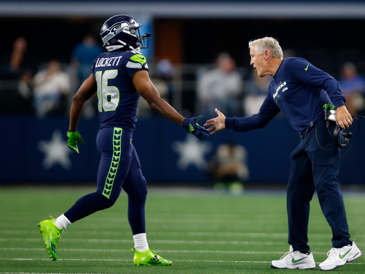 Wide receiver Tyler Lockett of the Seattle Seahawks smiles between