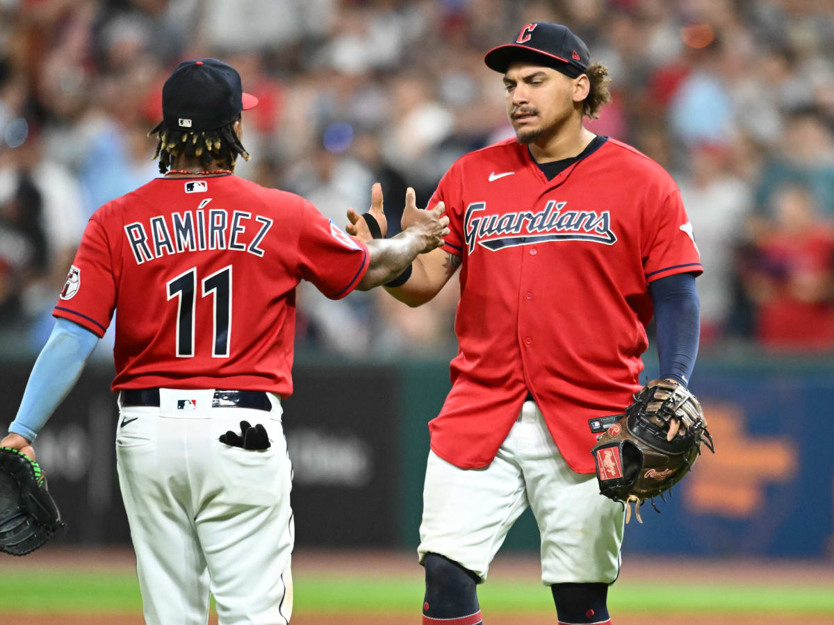 Cleveland Guardians' Josh Bell, left, and Jose Ramirez pose after