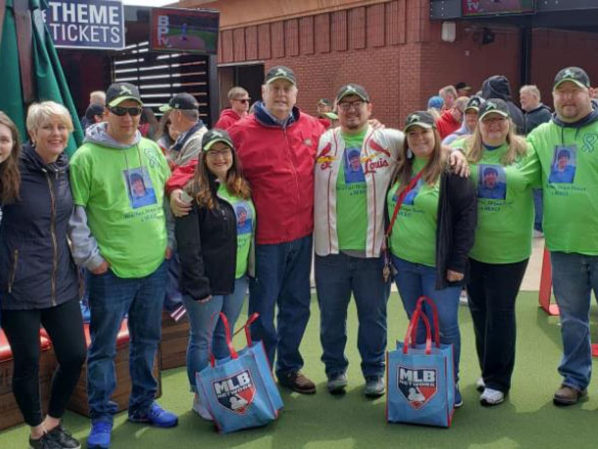 Transplant survivor tosses first pitch at Cardinals game