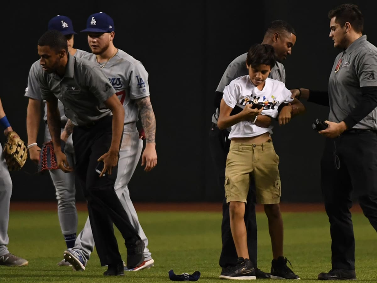 Photos: Fan rushes field during Rockies-Yankees game