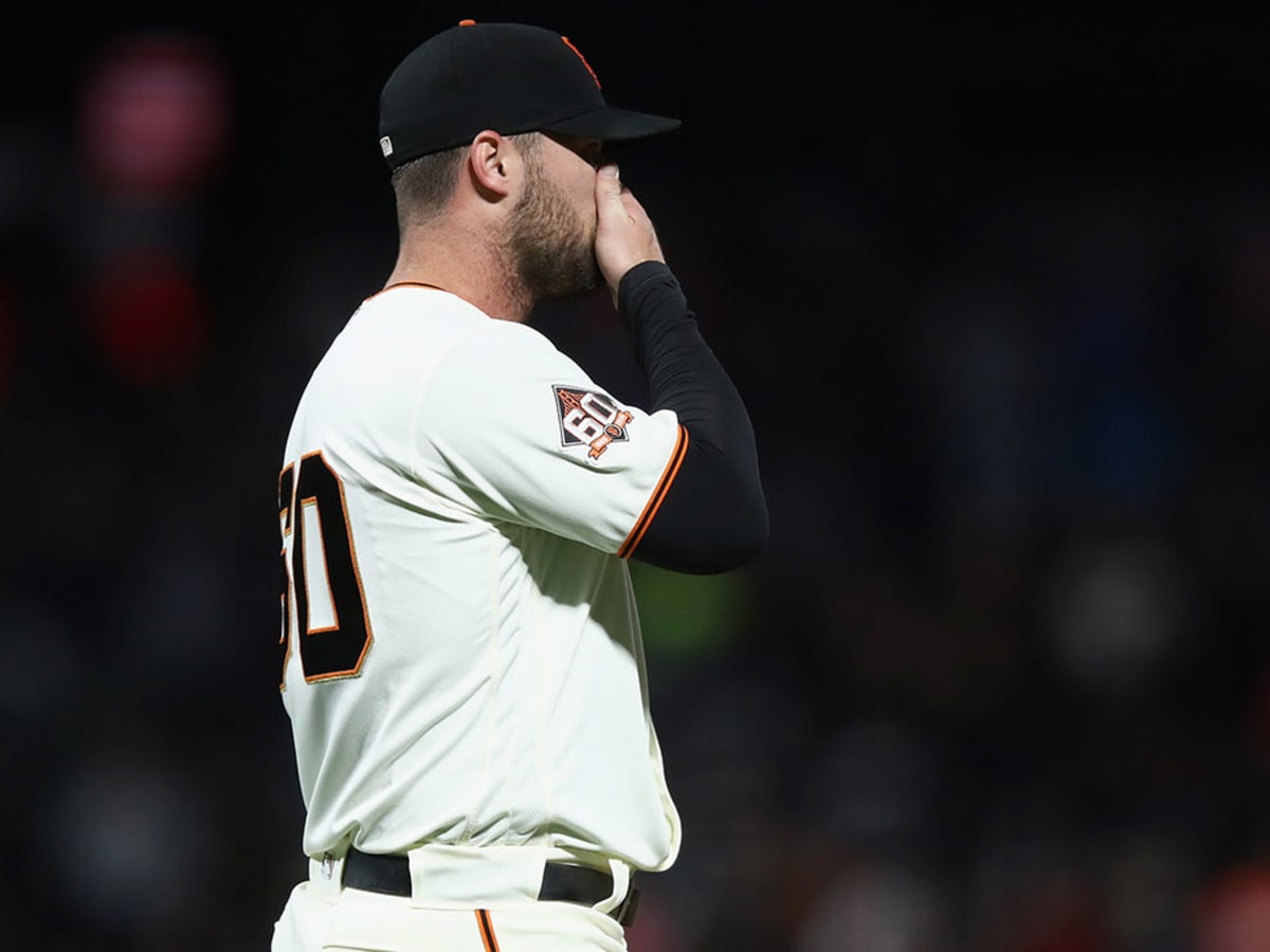 San Francisco Giants Madison Bumgarner blows on his hand during