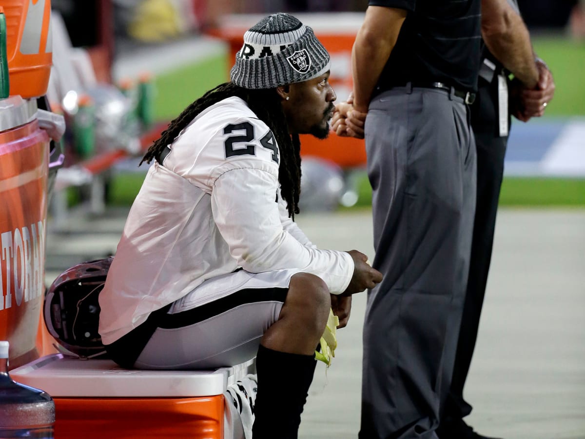 Raiders RB Marshawn Lynch sits during anthem before Rams game