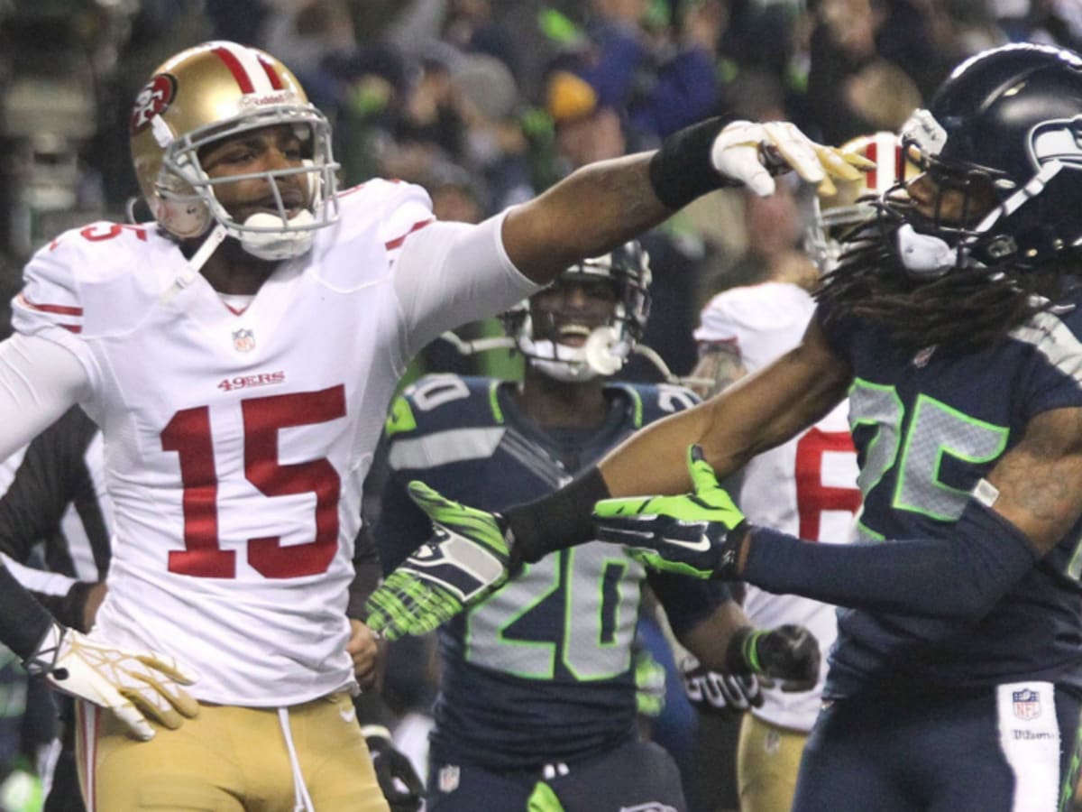 San Francisco 49ers cornerback Richard Sherman (25) is greeted by teammates  after Sherman inter …