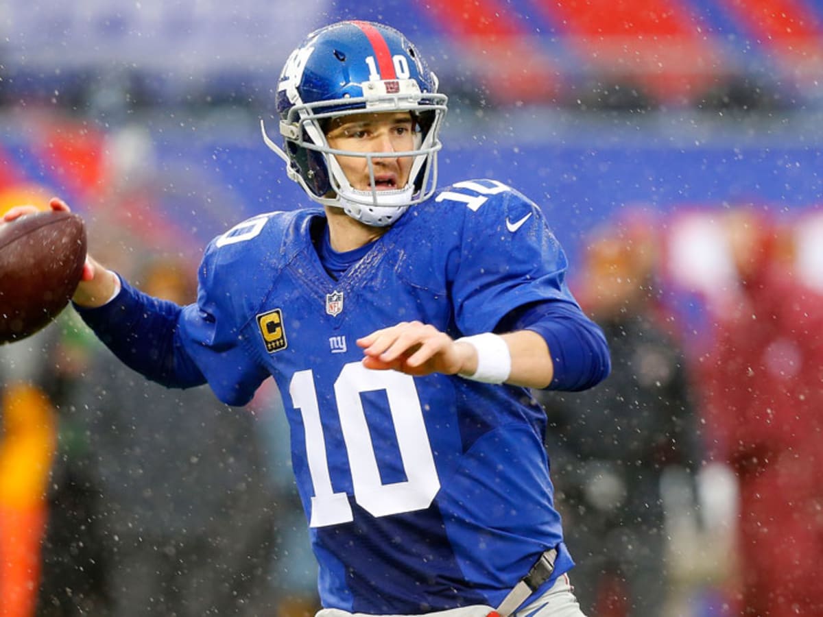 16 August 2010: New York Giants quarterback Eli Manning (10) gets tackled  and looses his helmet during first half of action of the New York Giants at  the New York Jets preseason