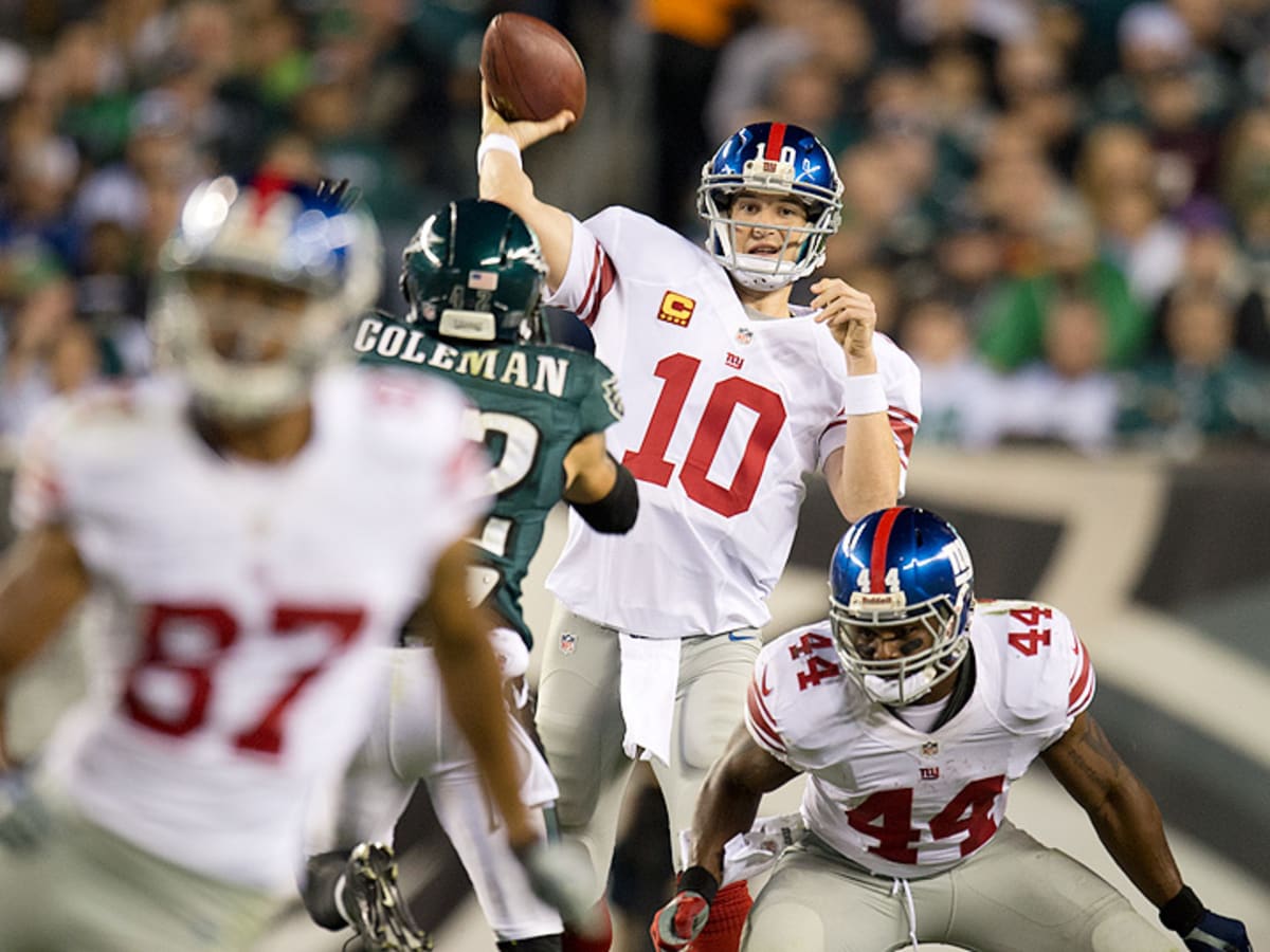 New York Giants Eli Manning puts his hands on his helmet in the