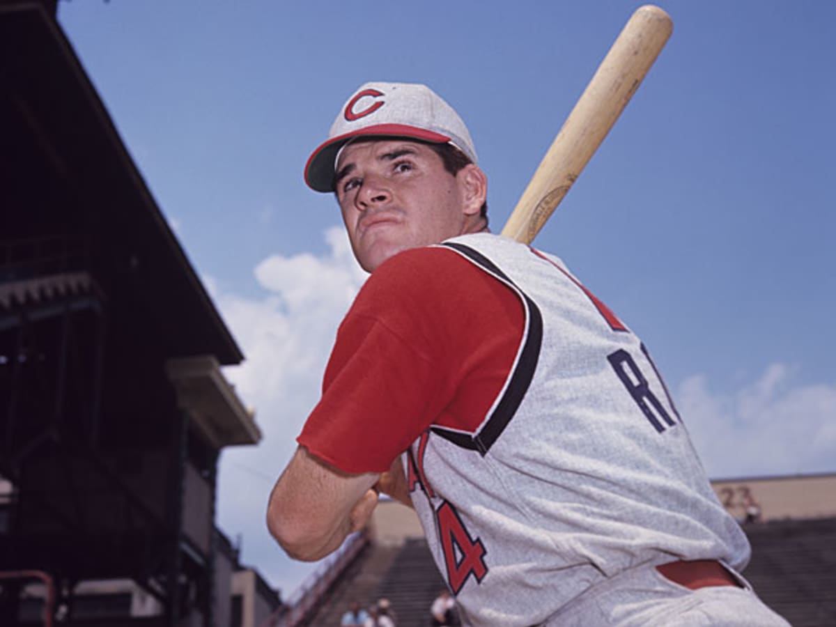 Former Cincinnati Reds manager Pete Rose hits a softball during