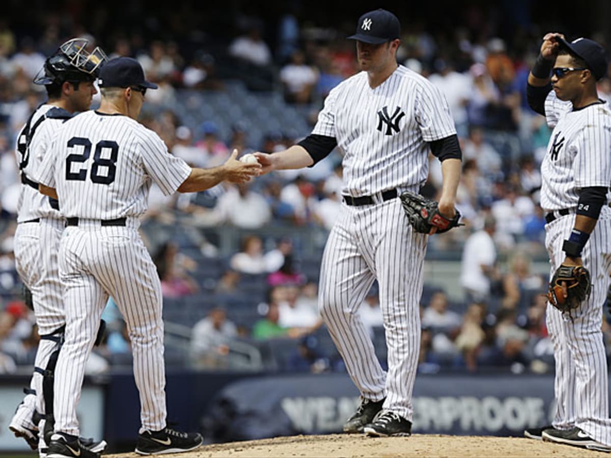 New York Yankees pitcher Joba Chamberlain is shown with his two