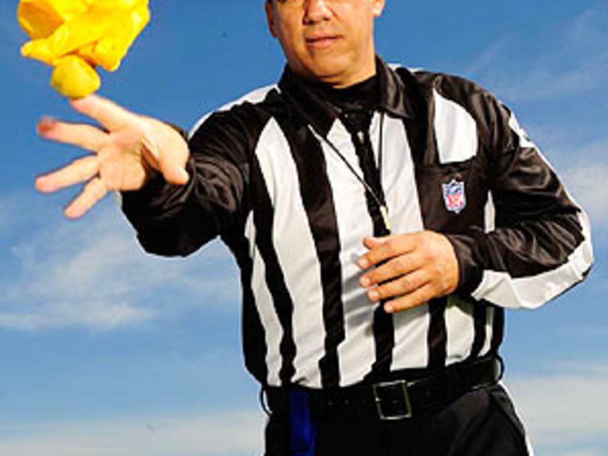 NFL referees discuss a penalty flag thrown during the second half of an NFL  playoff game betwee …