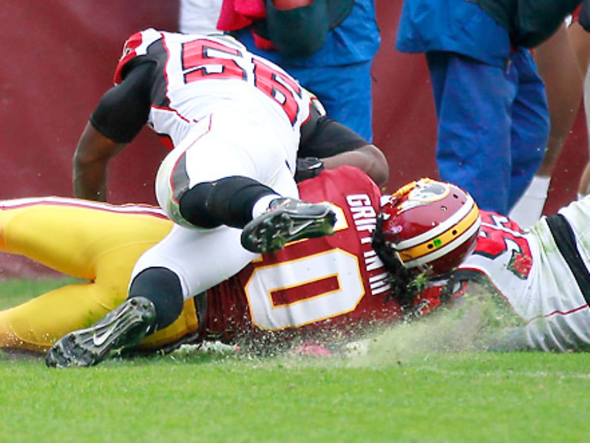 Former NFL quarterback Robert Griffin III walks on the sideline