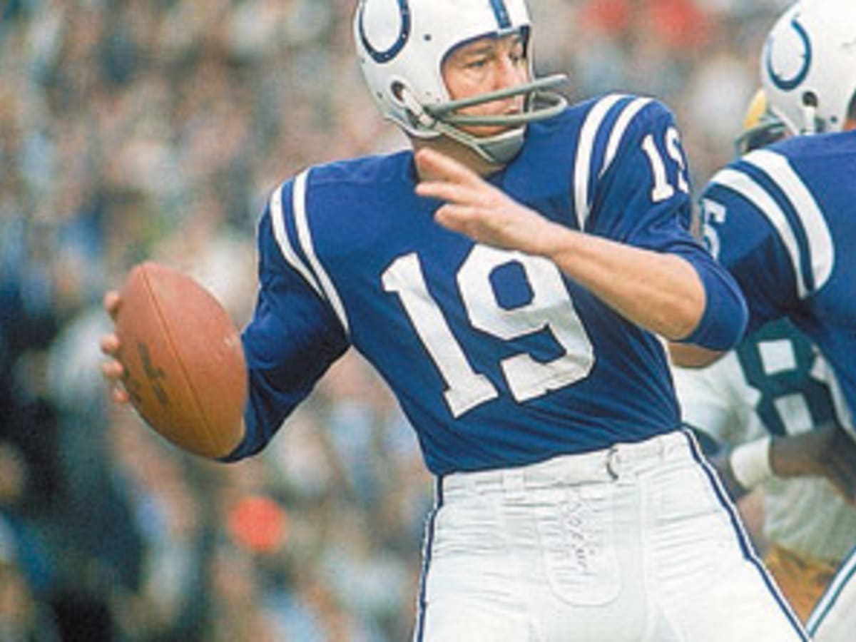 Quarterback John Unitas, unable to get off a pass, has the painstaking job  of holding onto the ball while Cincinnati defenders close in. The Bengals  are Steve Shomyszak and Royce Berry (82).