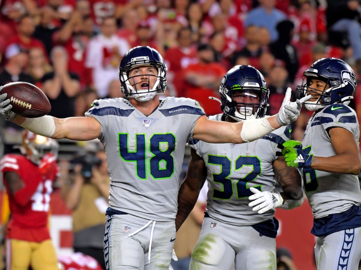 Seattle Seahawks tight end Jacob Hollister (48) scores a touchdown after a  reception as he is t …