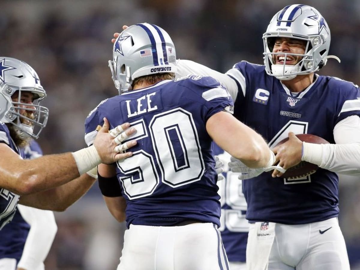 IMAGE DISTRIBUTED FOR JCPENNEY - Dallas Cowboys linebacker Sean Lee, left,  shops alongside Ajion Lair, 18, from the Boys & Girls Club of Greater  Dallas as he selects gifts for his family