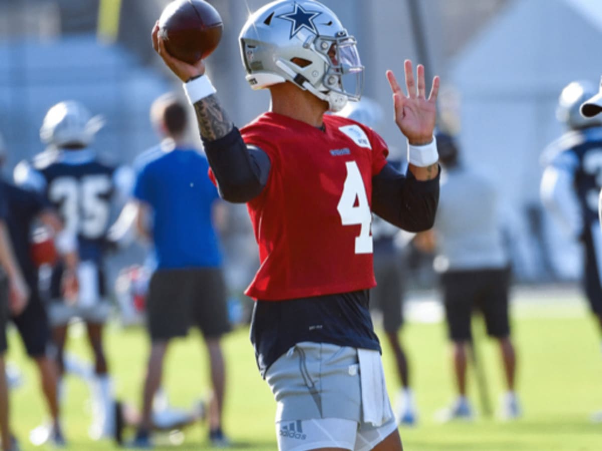 Dallas Cowboys quarterback Dak Prescott wears red as he lines up behind the  offensive line for a snap during an NFL football training camp in Frisco,  Texas, Monday, Aug. 24, 2020. (AP