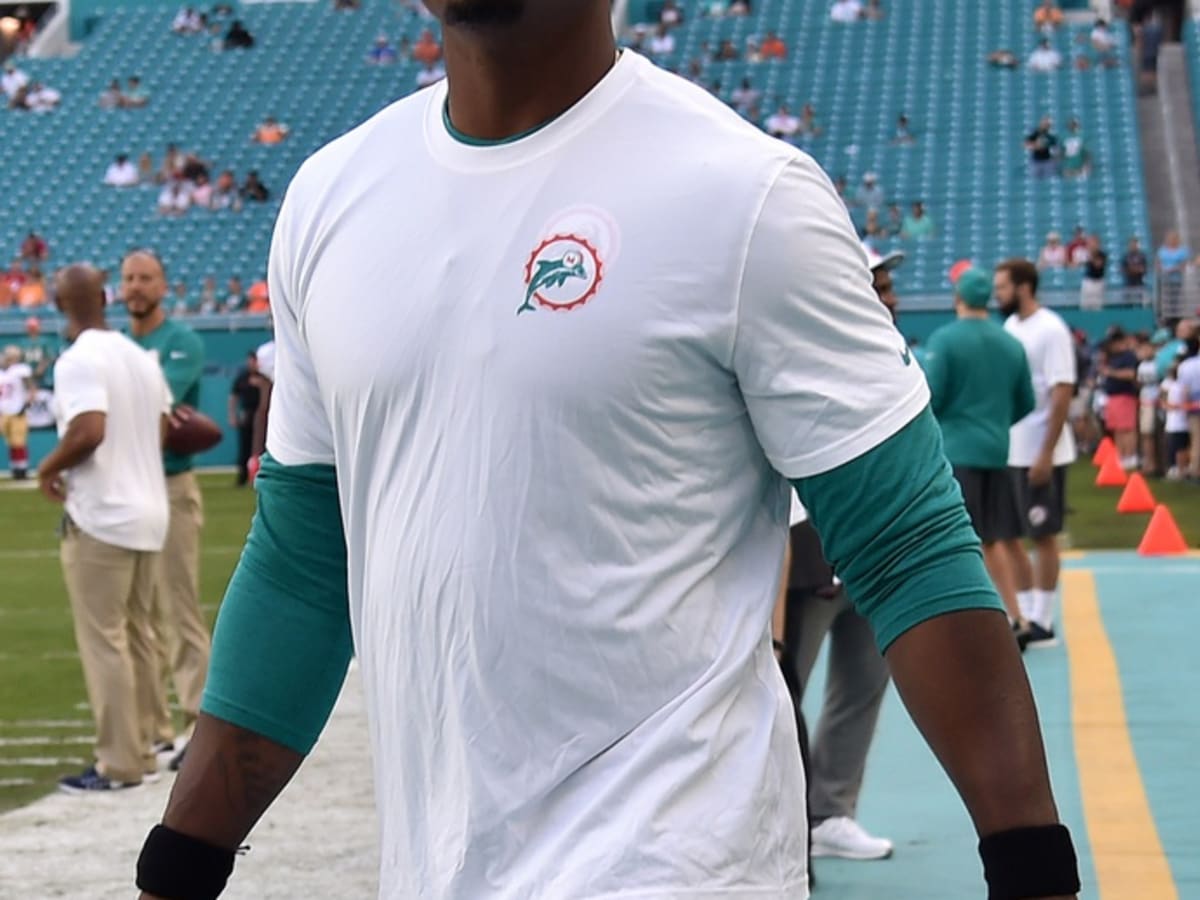 Dion Jordan, defensive end from Oregon, holds up a Dolphins Jersey after  the Miami Dolphins select him as the #3 overall pick in the 2013 NFL Draft  at Radio City Music Hall