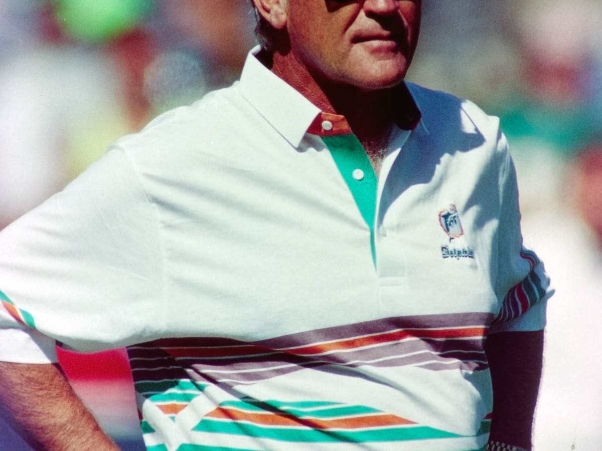 Mary Anne Shula hugs Tom Garfinkle, President and CEO of the Miami  Dolphins, during a ceremony honoring former head coach Don Shula during  half time of an NFL football game against the