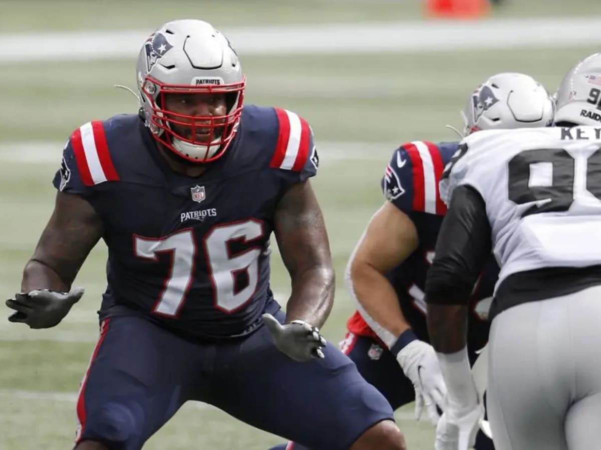 New England Patriots offensive tackle Isaiah Wynn (76) lifts up quarterback  Mac Jones (10) after a touchdown during the second half of an NFL football  game against the Cleveland Browns, Sunday, Nov.