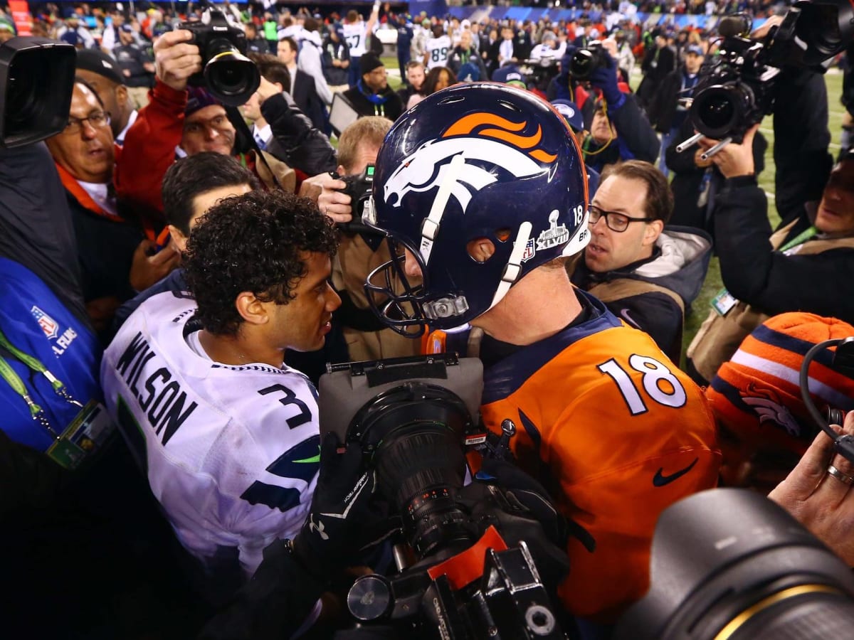 Peyton Manning and Russell Wilson take batting practice with the