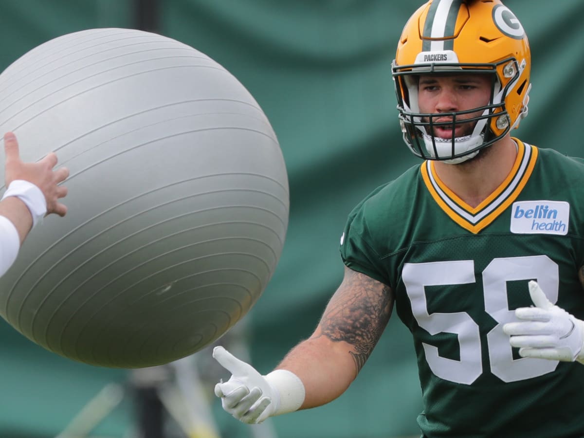 Green Bay Packers linebacker Isaiah McDuffie (58) picks up a loose ball  during an NFL football game against the Washington Commanders, Sunday, October  23, 2022 in Landover. (AP Photo/Daniel Kucin Jr Stock