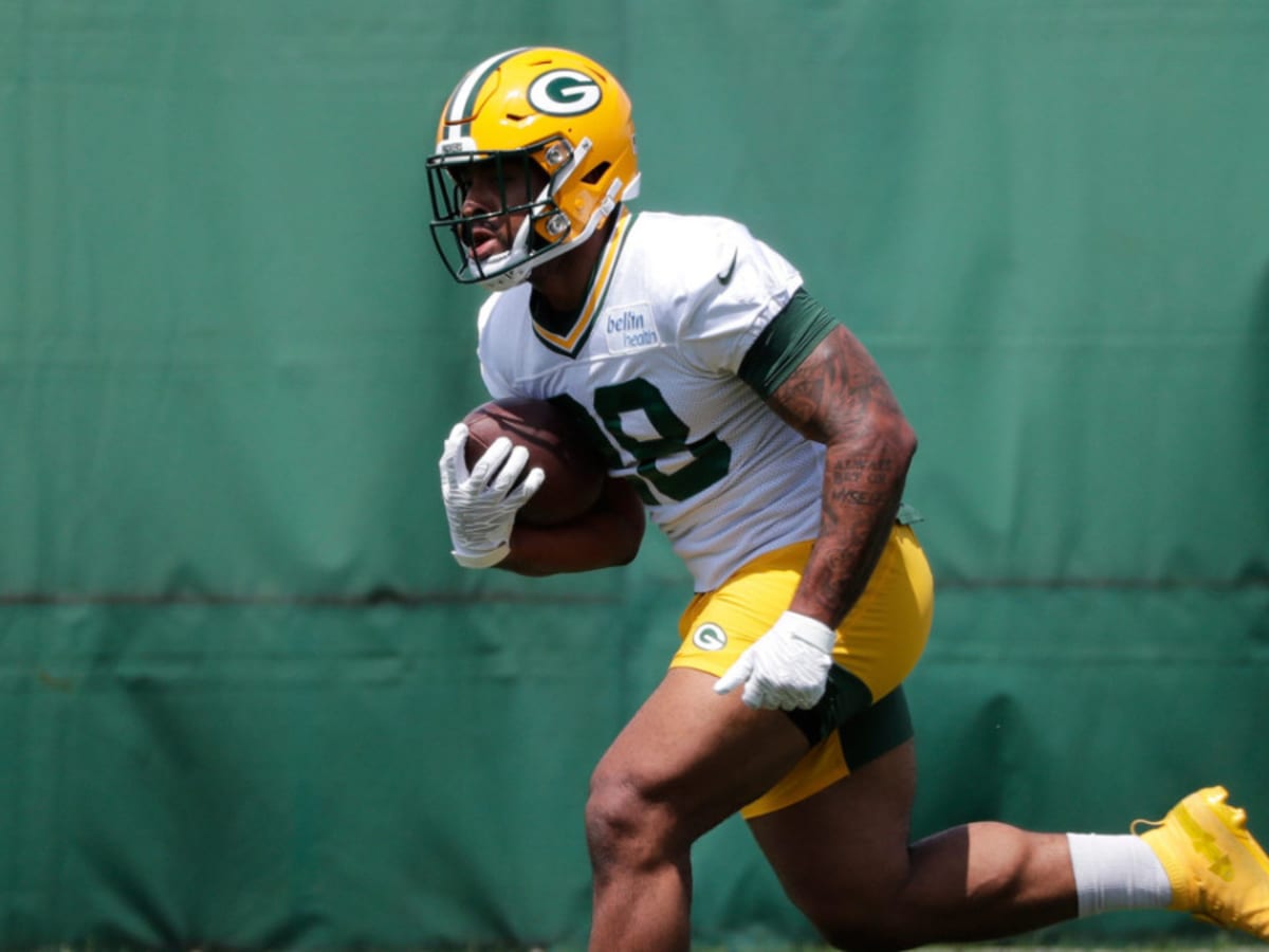 Green Bay Packers' AJ Dillon crushes a watermelon with his legs