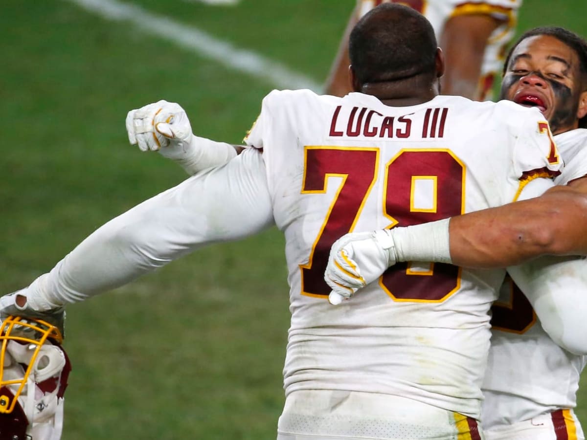 Washington Commanders offensive tackle Cornelius Lucas warms up