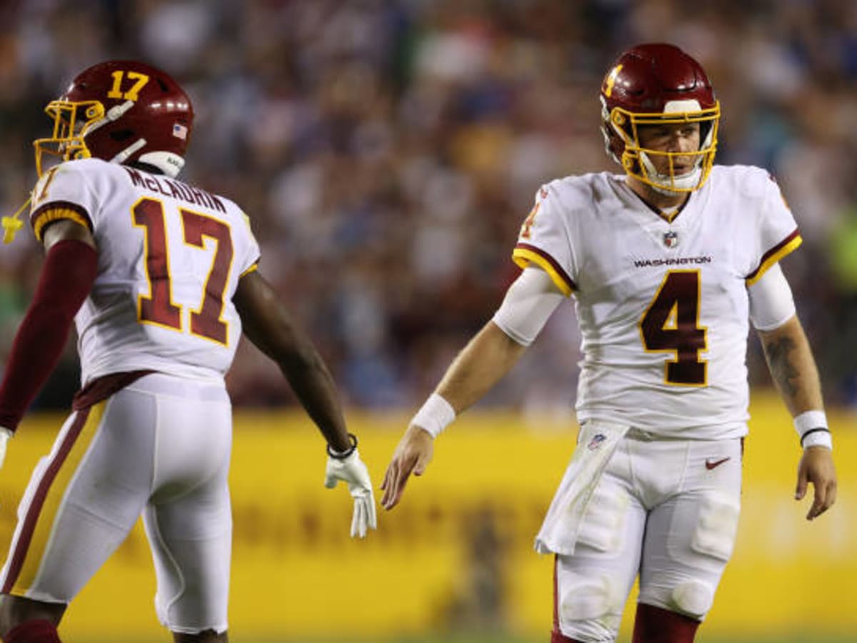 September 12, 2021: Washington Football Team quarterback Taylor Heinicke  (4) shovels the ball forward to Washington Football Team wide receiver Terry  McLaurin (17) after the scramble during the NFL regular season game